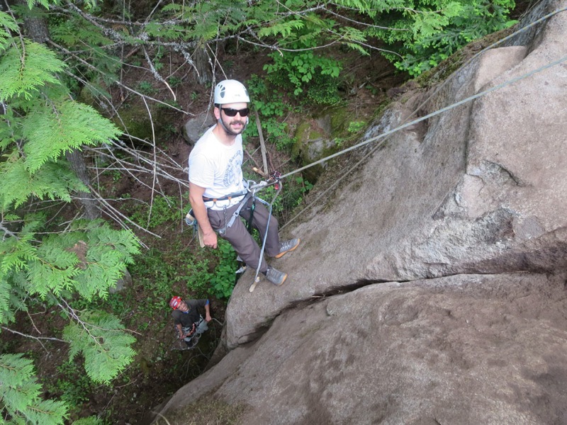 One man works hard building a rock climbing route in Ymir, British Columbia